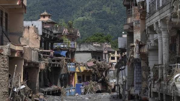 Debris and mud filling the streets between homes in a Nepali village